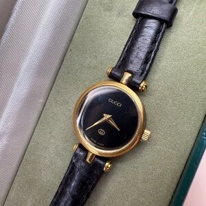 Gucci Black Leather strap with a midnight black dial from Gucci.